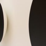 a black and white wall mounted speaker next to a white wall
